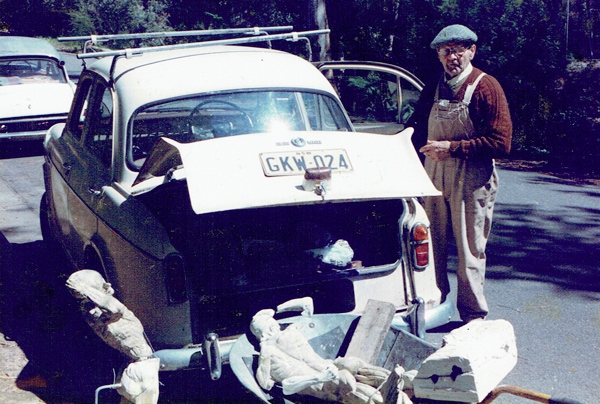 Arthur Murch with his Austin car and a wheelbarrow of plaster molds and castes